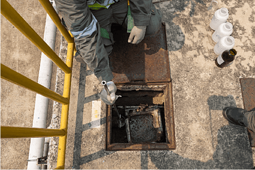 Taking Storm Water Samples from Storm Drain