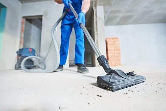 Man Vacuuming Industrial Facility